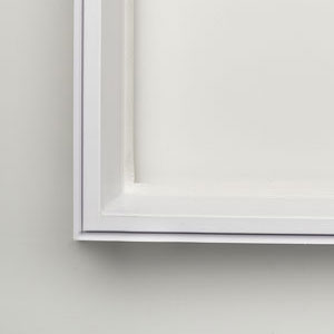 A white picture frame on the wall