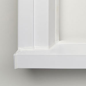 A white window sill with the bottom of it.