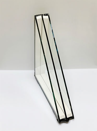 A glass sculpture of four sections with no visible lines.