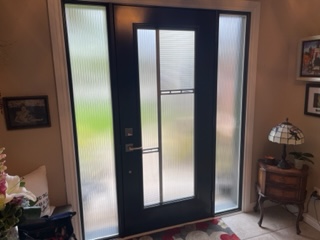 A black door with two windows and a glass window.