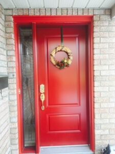 A red door with a window on one side