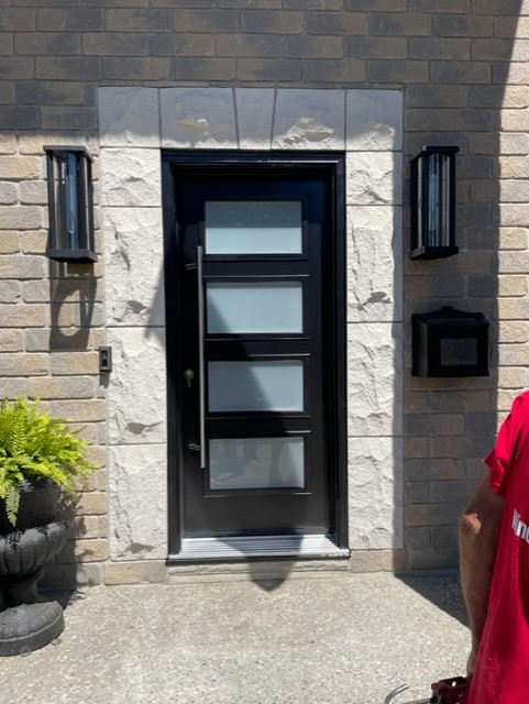 Outside view of a house with a designer glass door