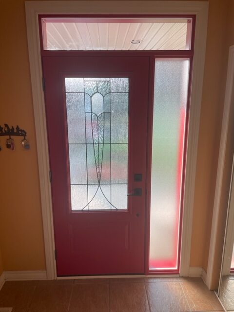 A red door with a glass window in the middle of it.