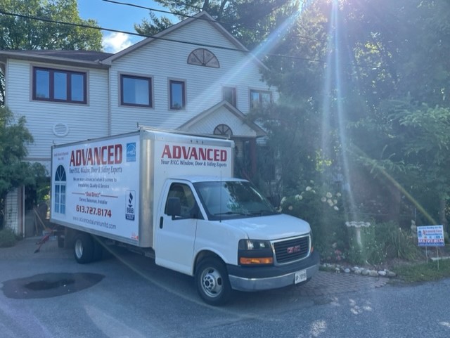 An advanced company truck parked outside a house