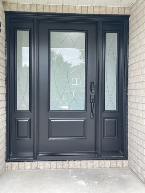A black door with two side panels and one window.